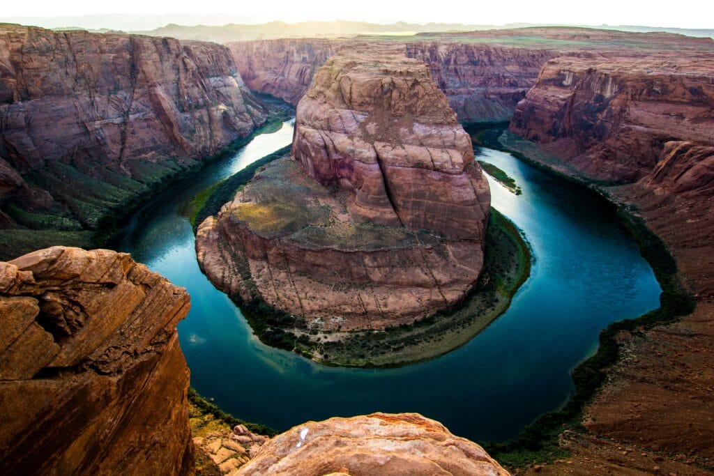 Breathtaking view of Horseshoe Bend with a tranquil river at sunset.